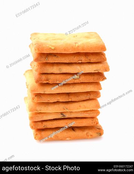Front view of stacked salted crackers with rosemary isolated on white