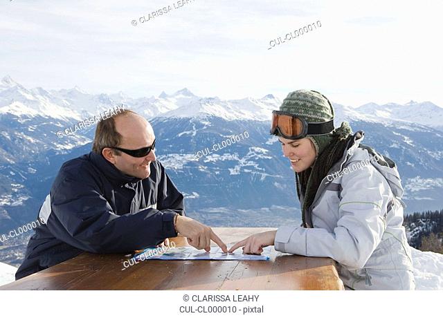 Man and young woman looking at map