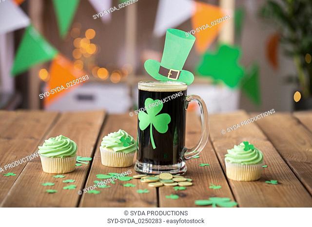 shamrock on glass of beer, green cupcakes and coins