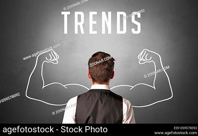 Rear view of a businessman with TRENDS inscription, powerfull business concept