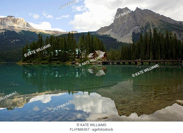 Rocky Mountains, cabins and pier reflecting in the water, Emerald Lake, Yoho National Park, British Columbia