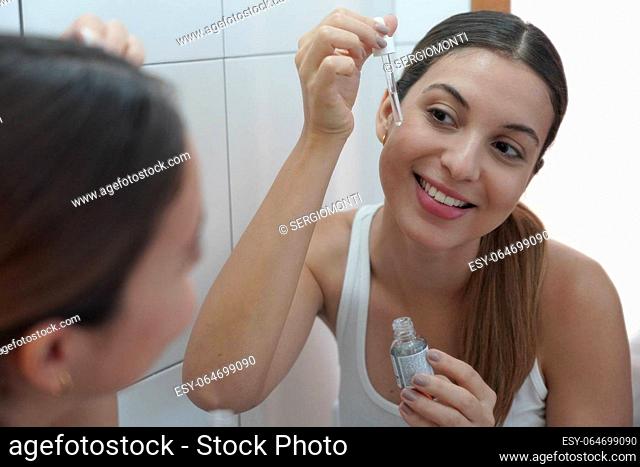 Skin Care Routine. Close-up of beautiful woman holding a pipette in her hand with serum moisturizing anti aging antioxidant
