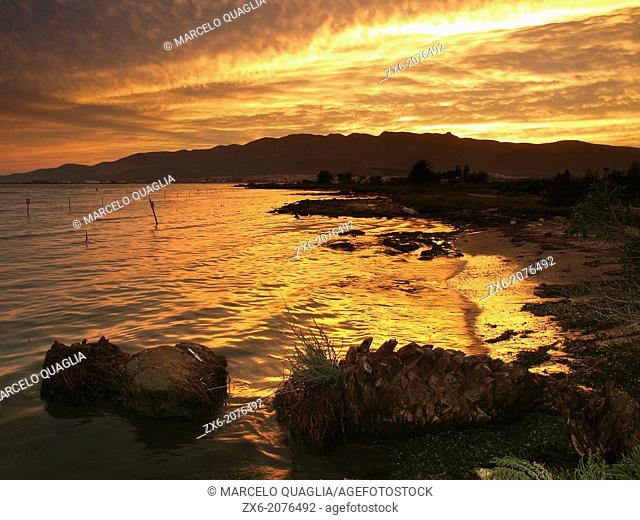Cloudy sunset at Alfacs Bay and Montsià Hills. Ebro River Delta Natural Park, Tarragona province, Catalonia, Spain