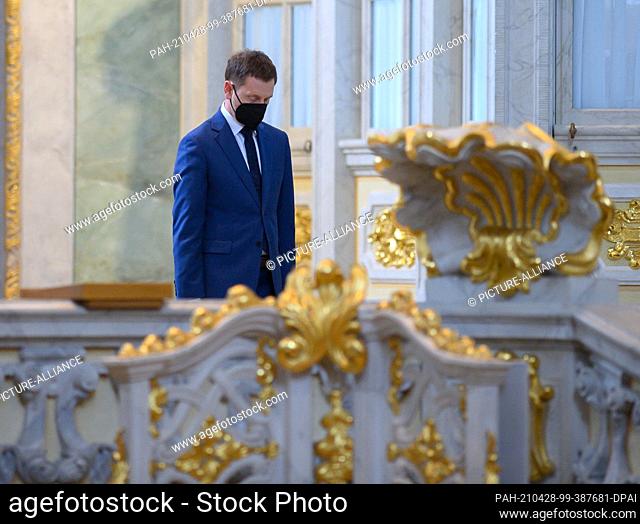 18 April 2021, Saxony, Dresden: Michael Kretschmer (CDU), Prime Minister of Saxony, takes his place in the Frauenkirche during a prayer service for the victims...