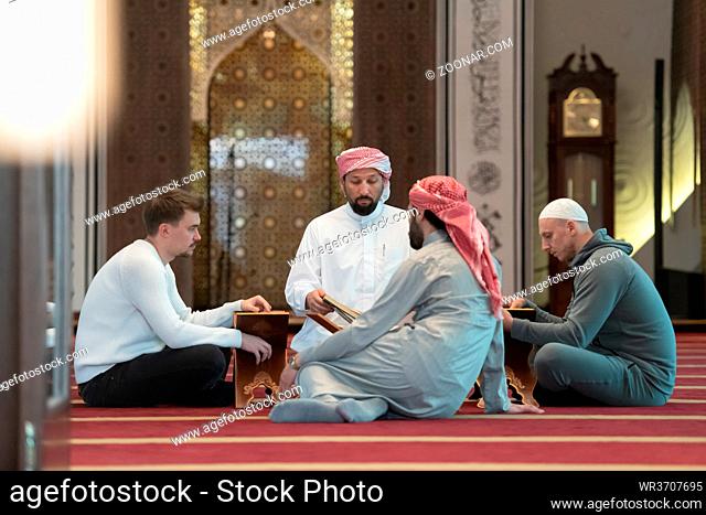 muslim people in mosque reading quran together concept of islamic education and school of holly book kuran