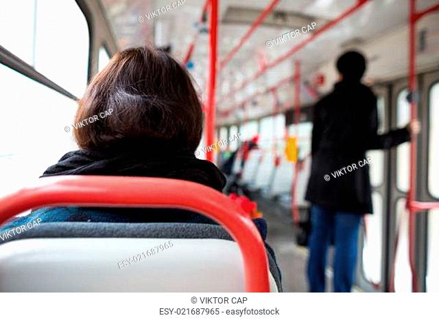 Public transport series - taking a tram commute to work/school (color toned image shallow DOF)
