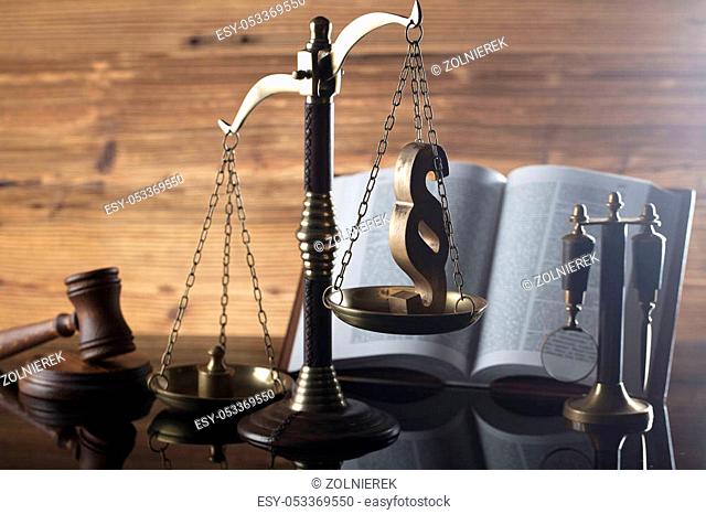 Law symbols. Judge wooden gavel, books and scale. Place for typography