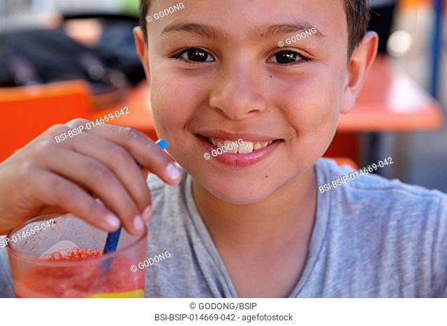 8-year-old boy drinking juice