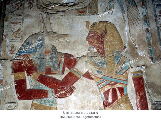 Painted relief depicting the Pharaoh and god Anubis, chapel of Osiris, Temple of Seti I, 1306-1290 bC, Abydos, Egypt. Egyptian civilisation, New Kingdom
