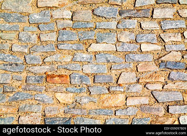 Stone pavement texture. Granite cobblestoned pavement background. Abstract background of old cobblestone pavement close-up