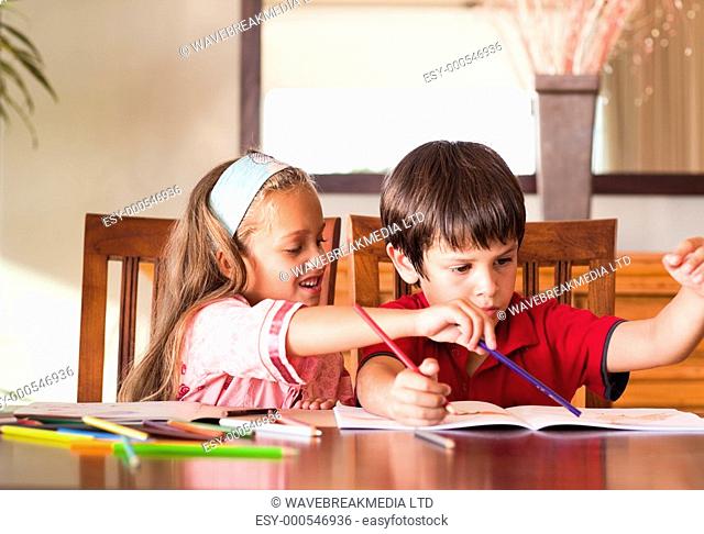 Children doing homework together at home