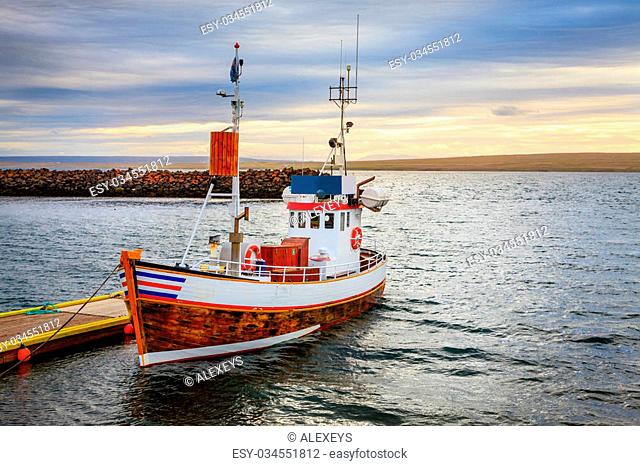 A small fishing boat at the pier in a small port in Northwestern Iceland