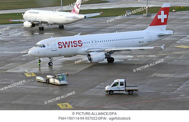14 January 2019, Lower Saxony, Hannover: An Airbus A320-214 of Swiss International Air Lines is taxiing to the take-off position on the southern runway of the...