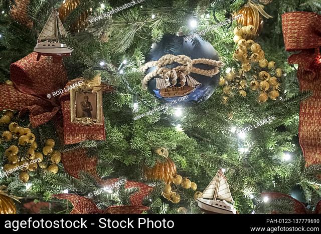 A depiction of US President John F. Kennedy’s official portrait is featured on ornaments hanging from a tree in The Vermeil Room of the White House during the...