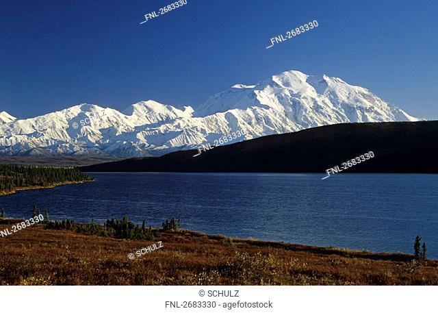Lake in front of snow covered mountain range, Mt McKinley, Wonder Lake, Denali National Park, Alaska, USA