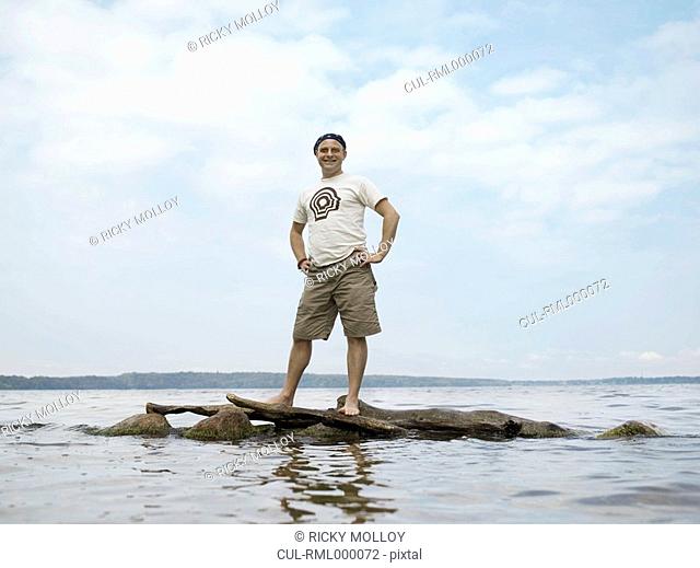 Man standing on rocks in water