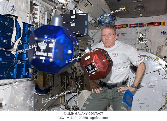 NASA astronaut Mike Fossum, Expedition 29 commander, performs a check on Synchronized Position Hold, Engage, Reorient, Experimental Satellites (SPHERES)...