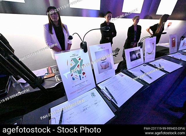 19 November 2023, Bavaria, Munich: Papers with bids for works of art are on display at the ""PIN Benefit Auction 2023"" organized by the Friends of the...