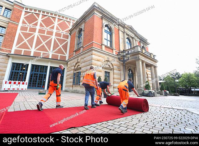 25 July 2023, Bavaria, Bayreuth: The red carpet is fixed in front of the Festspielhaus on the Grüner Hügel for the opening of the Bayreuth Richard Wagner...