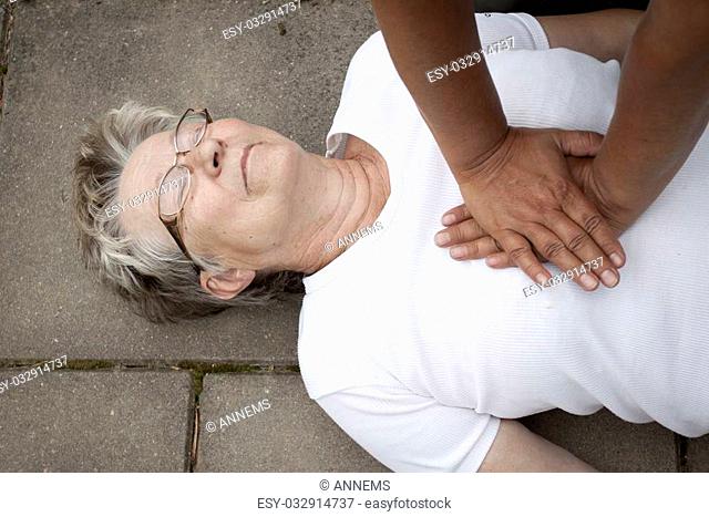 A senior lade with cardiac arrest or stroke receiving cpr