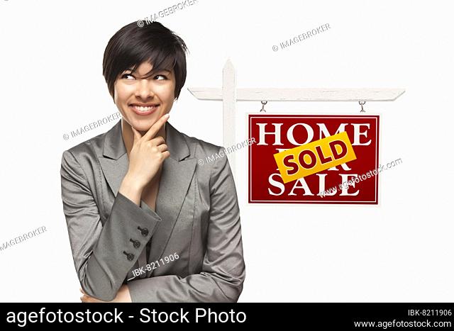 Ethnic woman in front of sold home for sale real estate sign isolated on a white background