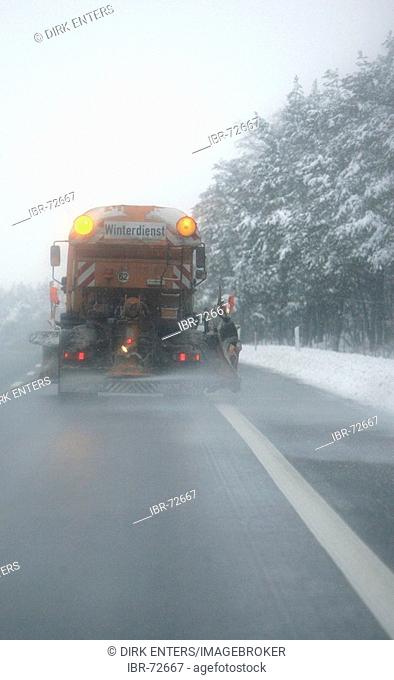 Snow clearing service spreads salt on a german Autobahn