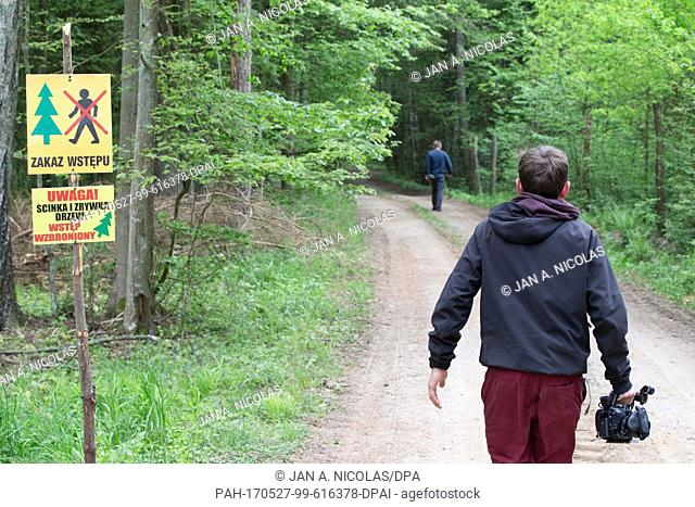 Journalists seen next to no-trespassing signs put up a few days prior following a decree on limiting access to logging areas in the Bialowieza Forest World...