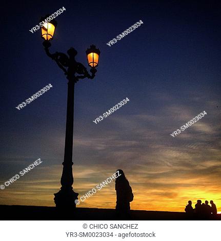 An man walks at sunset in Cadiz, Andalusia, Spain