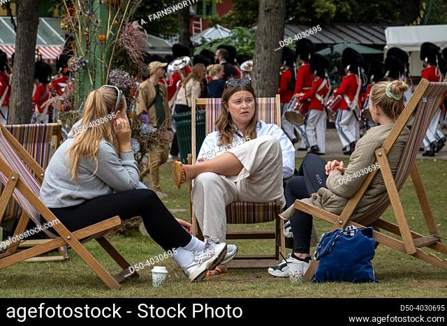 Copenhagen, Denmark People laounging in garden chairs at Tivoli Gardens