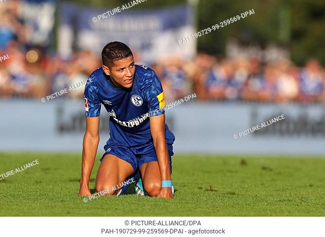 29 July 2019, Austria, Kitzbühel: Soccer: Test matches, FC Schalke 04 - FC Bologna. Schalke's Amine Harit lies exhausted on the lawn