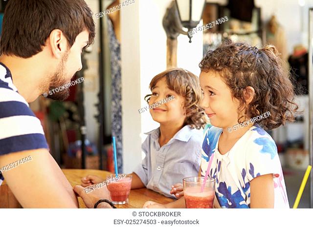Children Drinking Fruit Smoothies In Restaurant