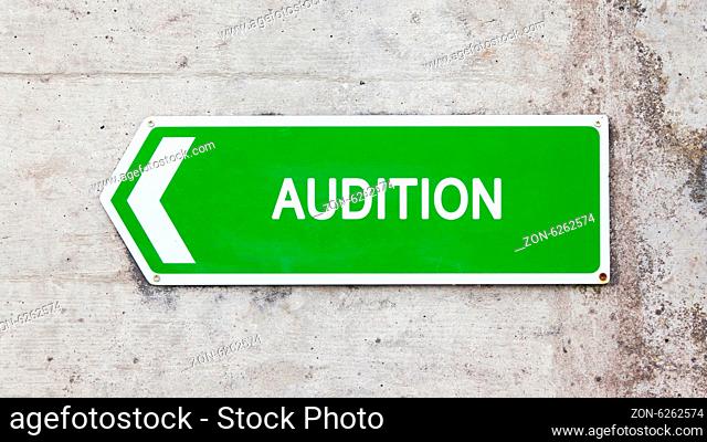 Green sign on a concrete wall - Audition