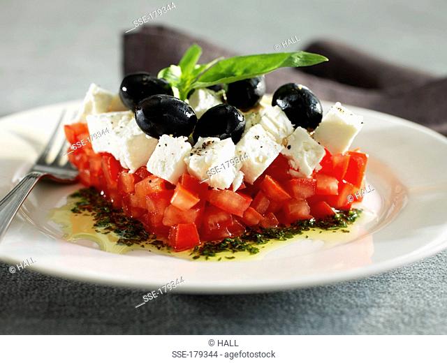 Thinly diced tomatoes with feta and black olives
