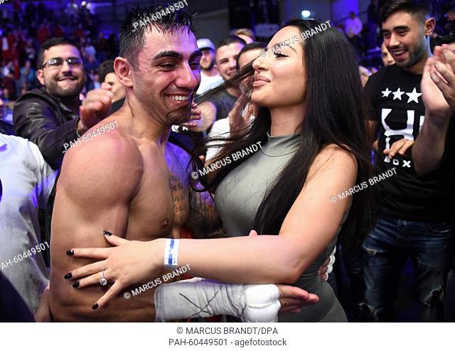 Artem Harutyunyan (l) embraces his fiancee Karina after winning the qualification bout for the 2016 Rio Olympic Games against Abdelkader Chadi (not in picture)...
