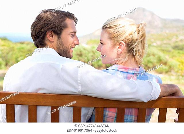 Cute couple sitting on bench together
