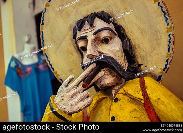 Statue of a Mexican man with sombrero smoking a cigar