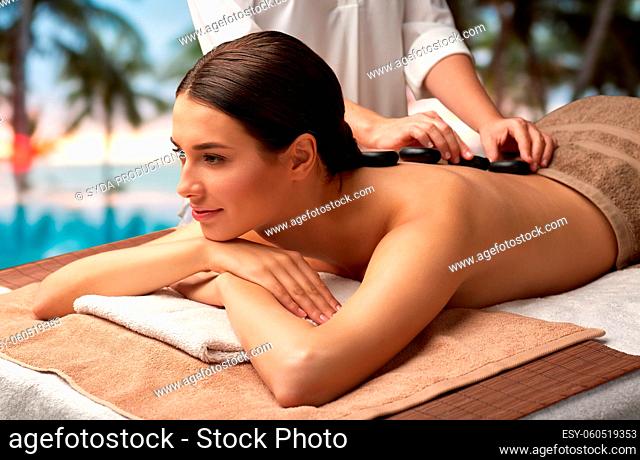 beautiful woman having hot stone massage at spa