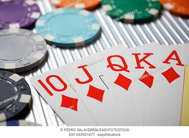 Cards and casino chips on a metal surface