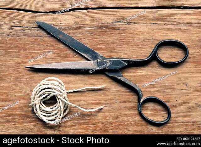 vintage scissors and hank yarn on the red wooden table background