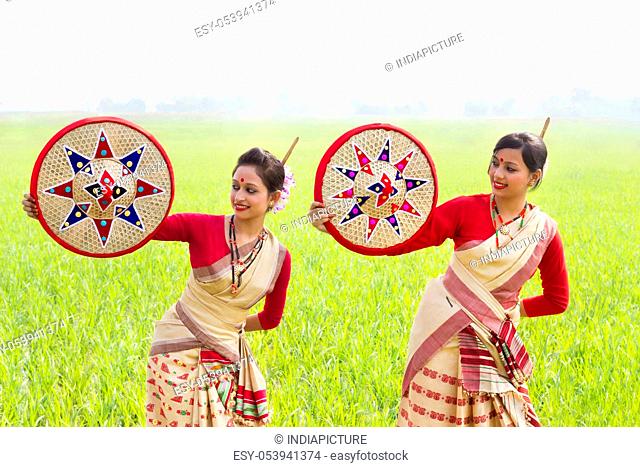 Bihu women holding jaapis