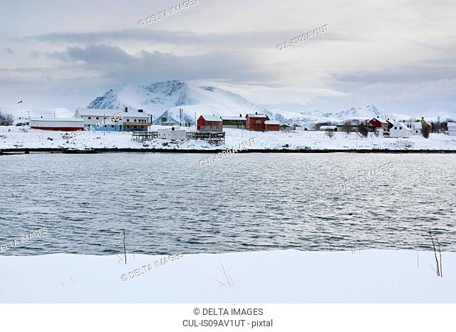 Snow covered landscape and distant houses, Andenes, Lofoten Islands, Norway