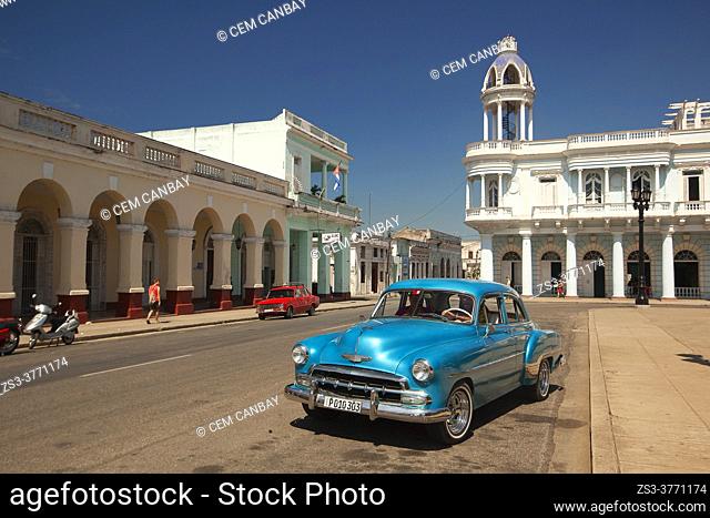 American car in front of the colonial buildings at Parque Jose Marti with Palacio Ferrer at the background, Cienfuegos, Cienfuegos Province, Cuba, West Indies