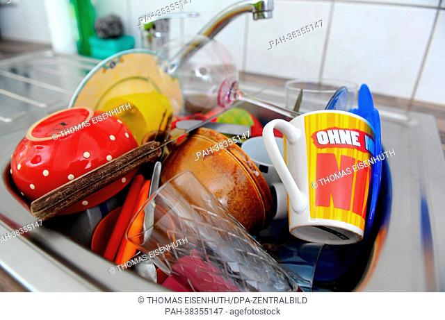 Dirty dishes are stacked in a sink in Dresden, Germany, 19 March 2013. Photo: Thomas Eisenhuth | usage worldwide. - Dresden/Saxony/Germany