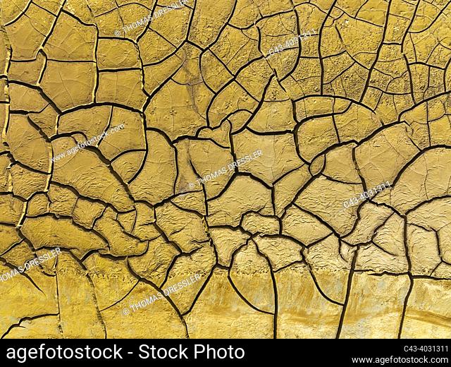 Mineral-rich cracked earth at the bank of the Rio Tinto (Red river). Aerial view. Drone shot. Huelva province, Andalusia, Spain