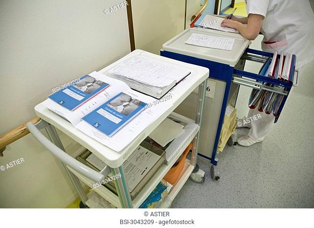 Photo essay at the maternity of Saint-Vincent de Paul hospital, Lille, France. Midwife with medical files and baby health records