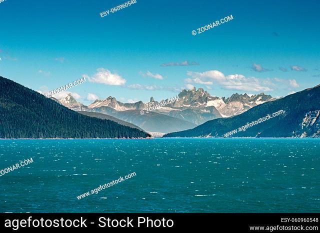 Entrance to the frigid and cold teal colored glacial waters of beautiful and windy Taku Inlet, south of Juneau, Alaska, USA