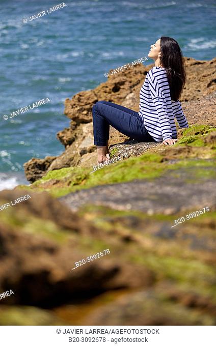 Woman in sailor clothes, Costa rocks, Plage du Port Vieux, Biarritz, Pyrenees Atlantiques, France, Europe