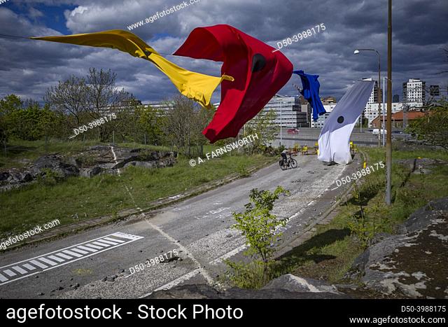 Stockholm, Sweden Multicoloered flags waving in the wind at an old and unused highway on-ramp turned into an artist installation