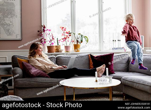 Mother with son on sofa