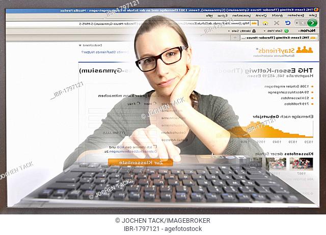 Young woman sitting at a computer surfing the Internet, viewing a page on Stayfriends.de, view from within the computer, symbolic image